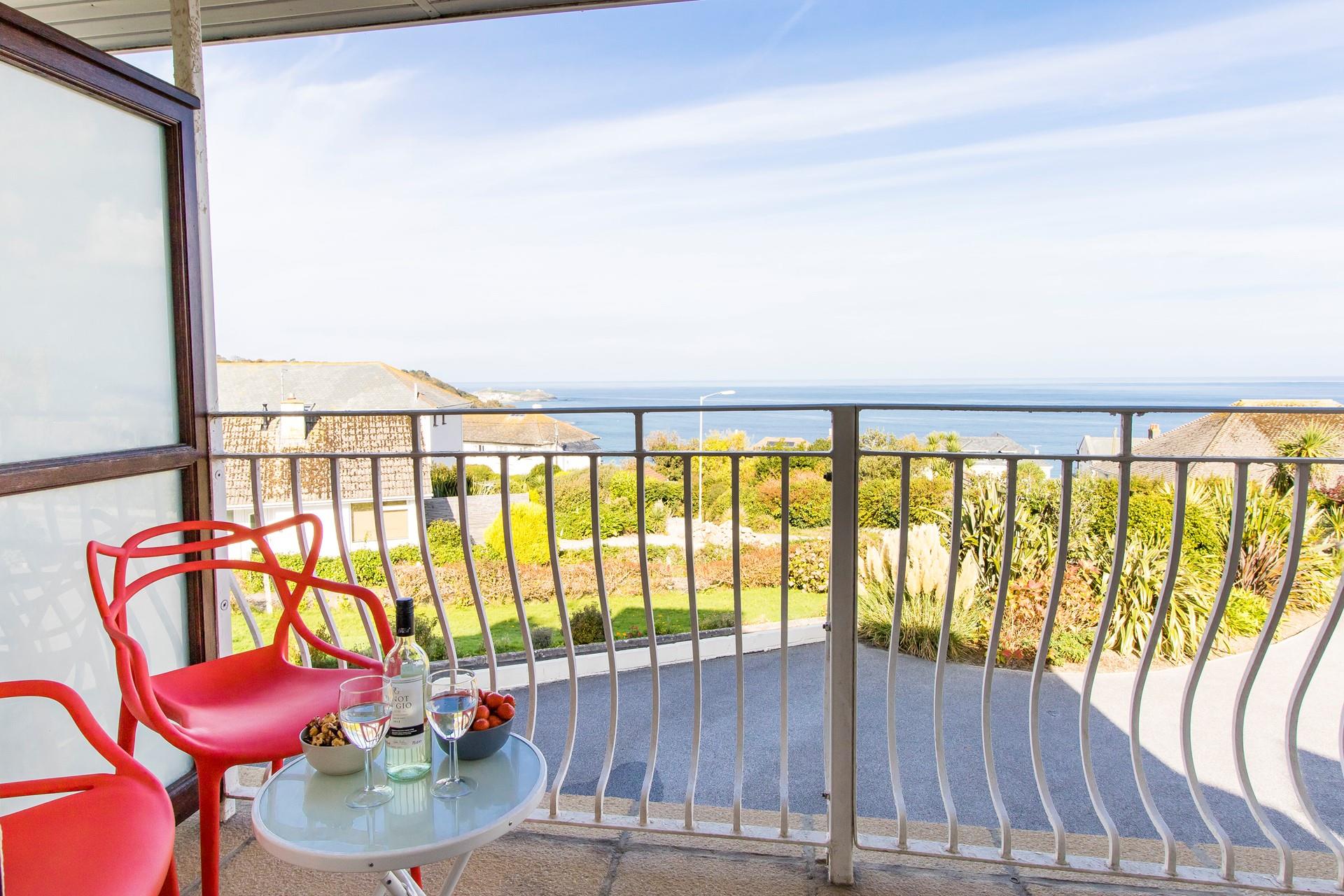 Indulge in a glass of your favourite tipple whilst relaxing on the private balcony. We love the pop of colour from the red chairs. 