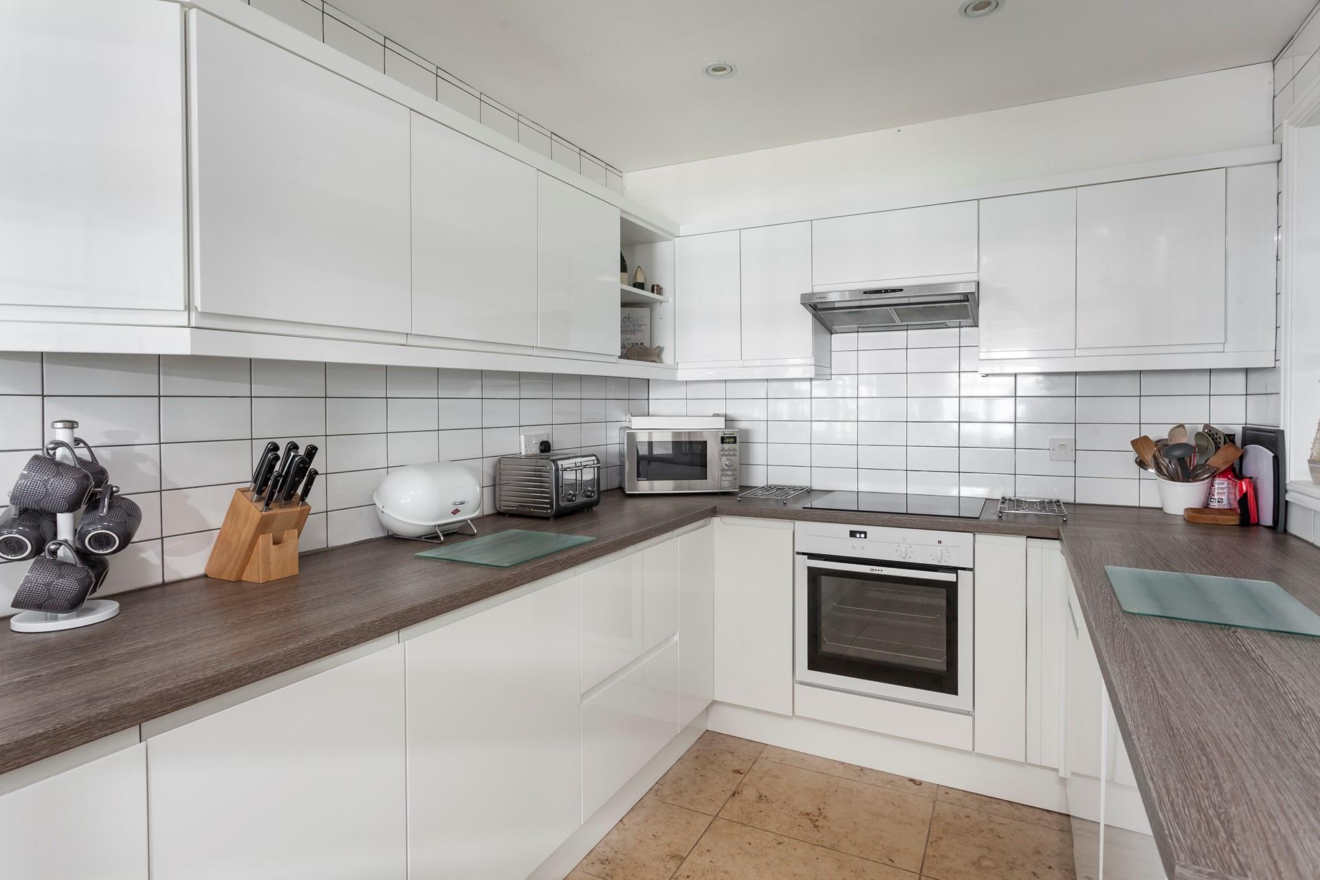 With beautiful gloss cabinets, the kitchen has a high-quality finish, with all you need for your stay. 