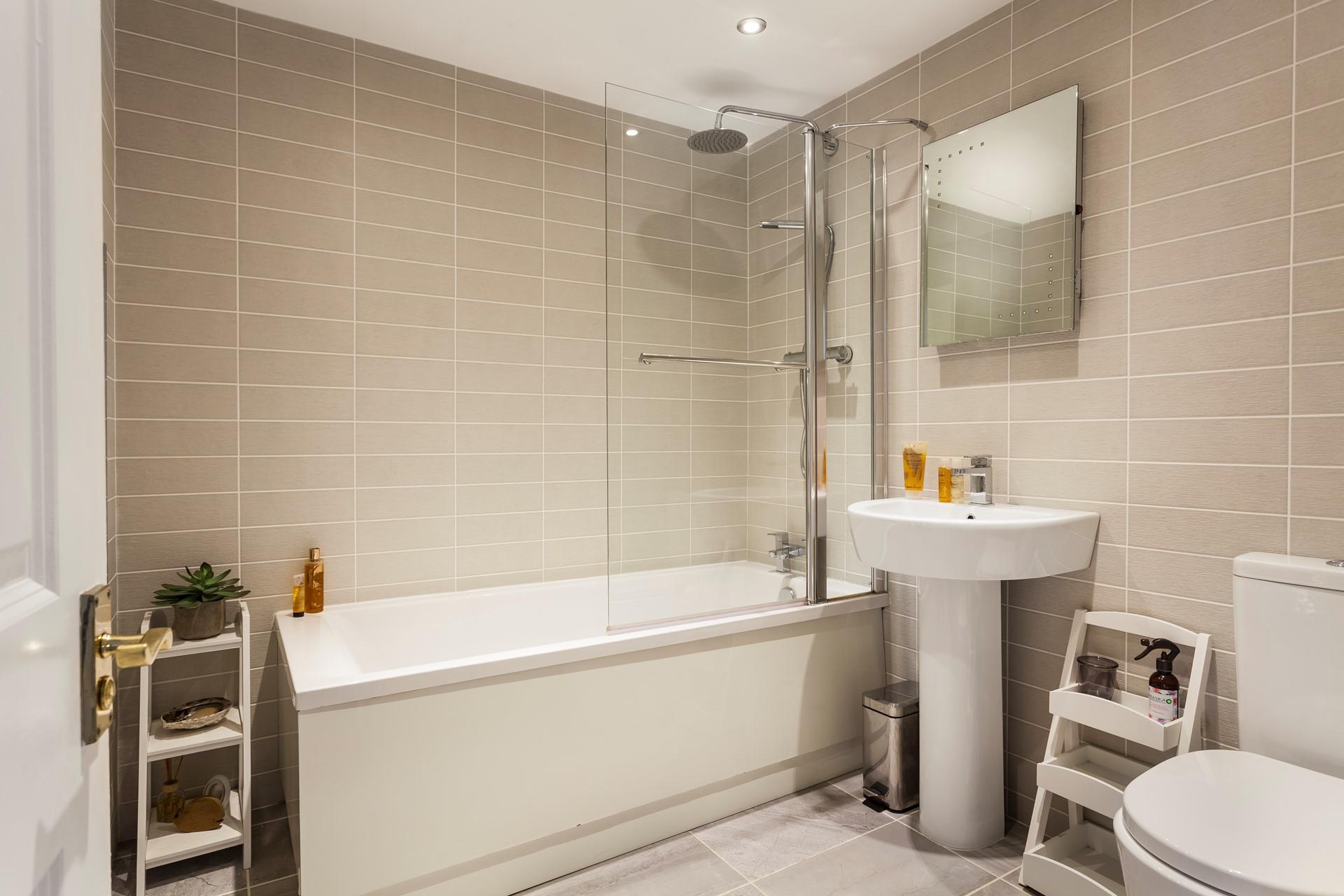 With a modern finish, the family bathroom is perfectly-sized for four. 