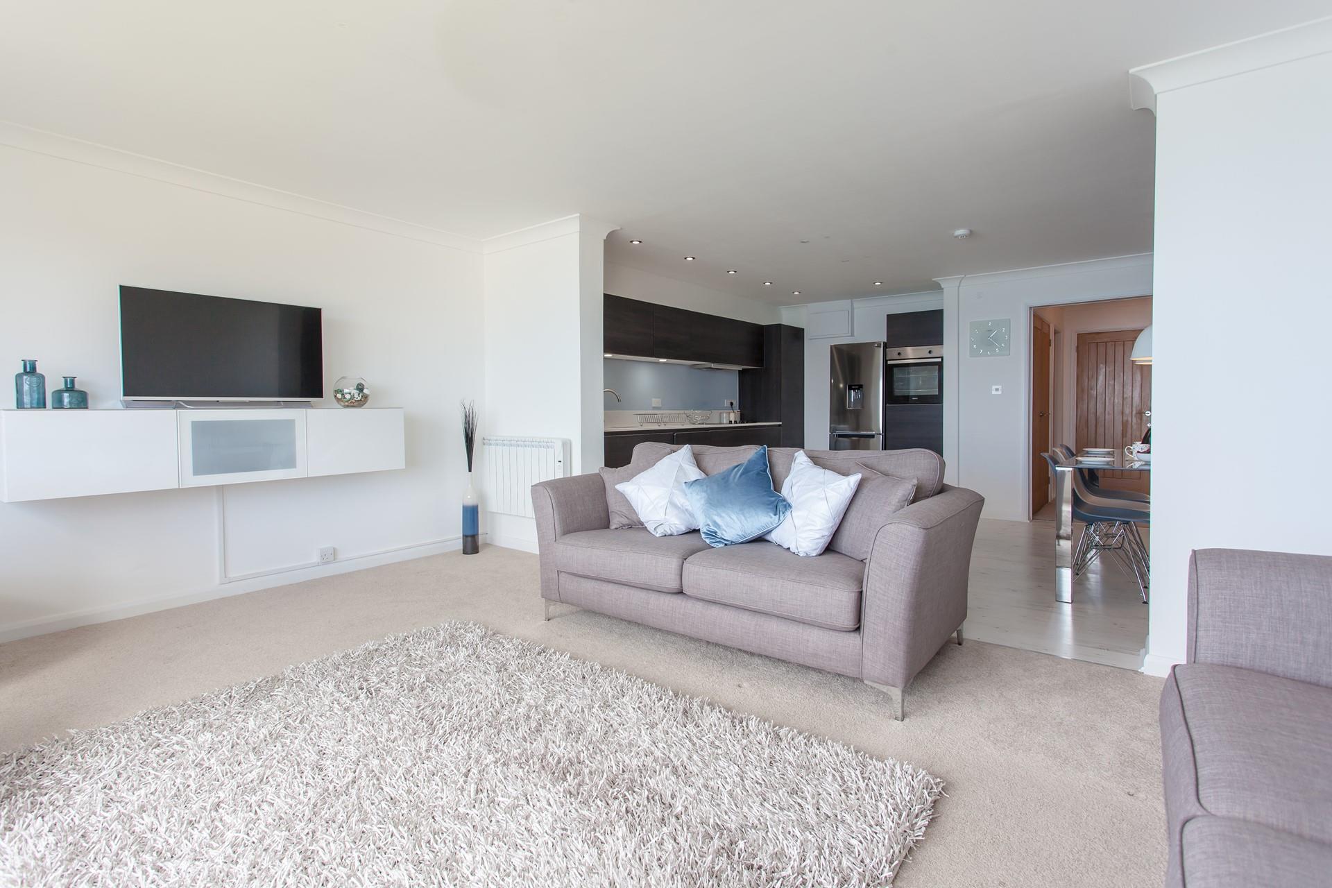 Modern and sleek, the open plan living area is light, spacious and airy. 