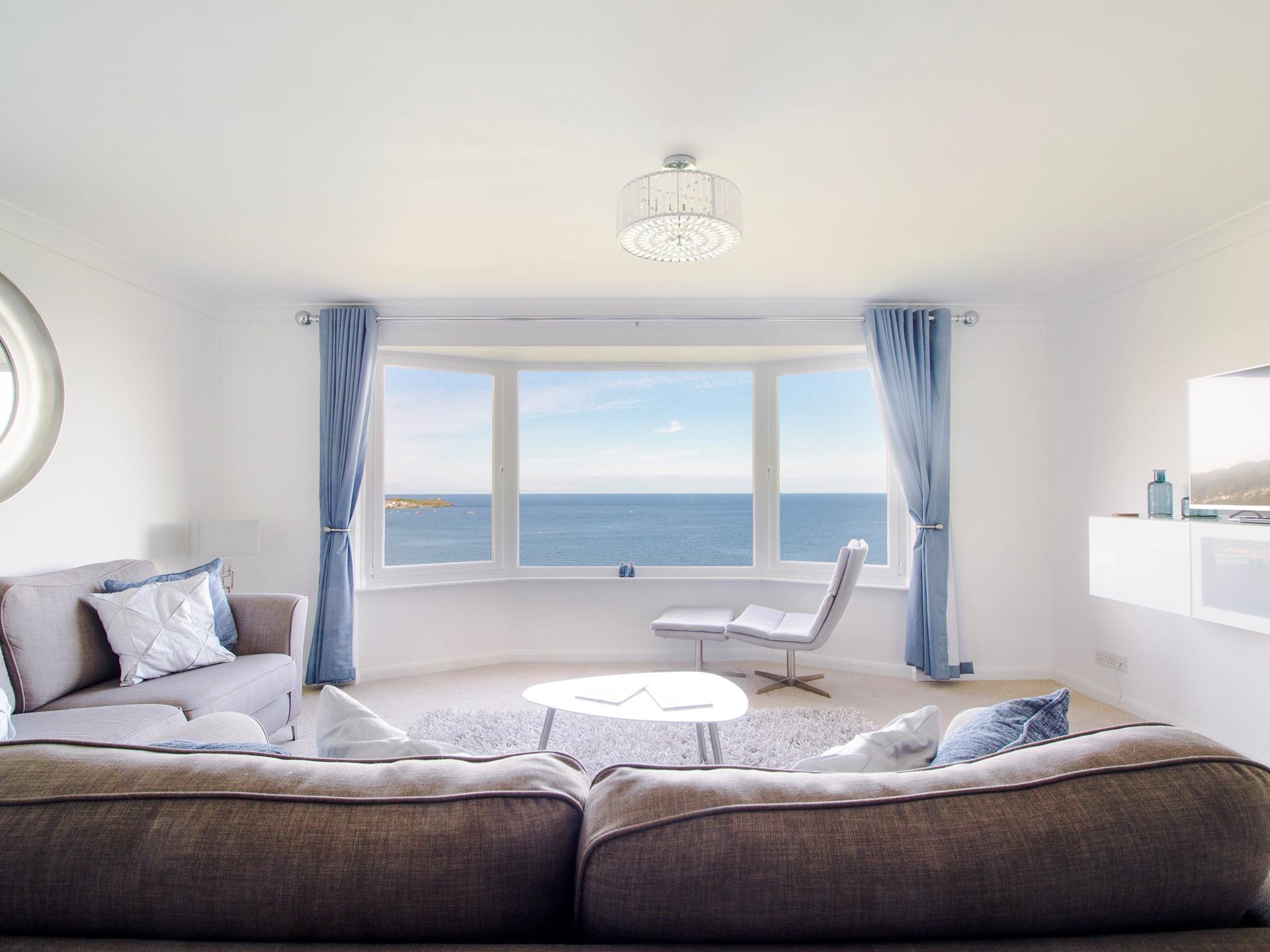 Cool blues and calming creams create a truly relaxing oasis of calm in the living area, framing the endless sea view. 