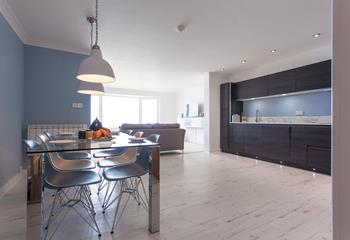 The contemporary kitchen benefits from the light streaming through the open plan living area. 
