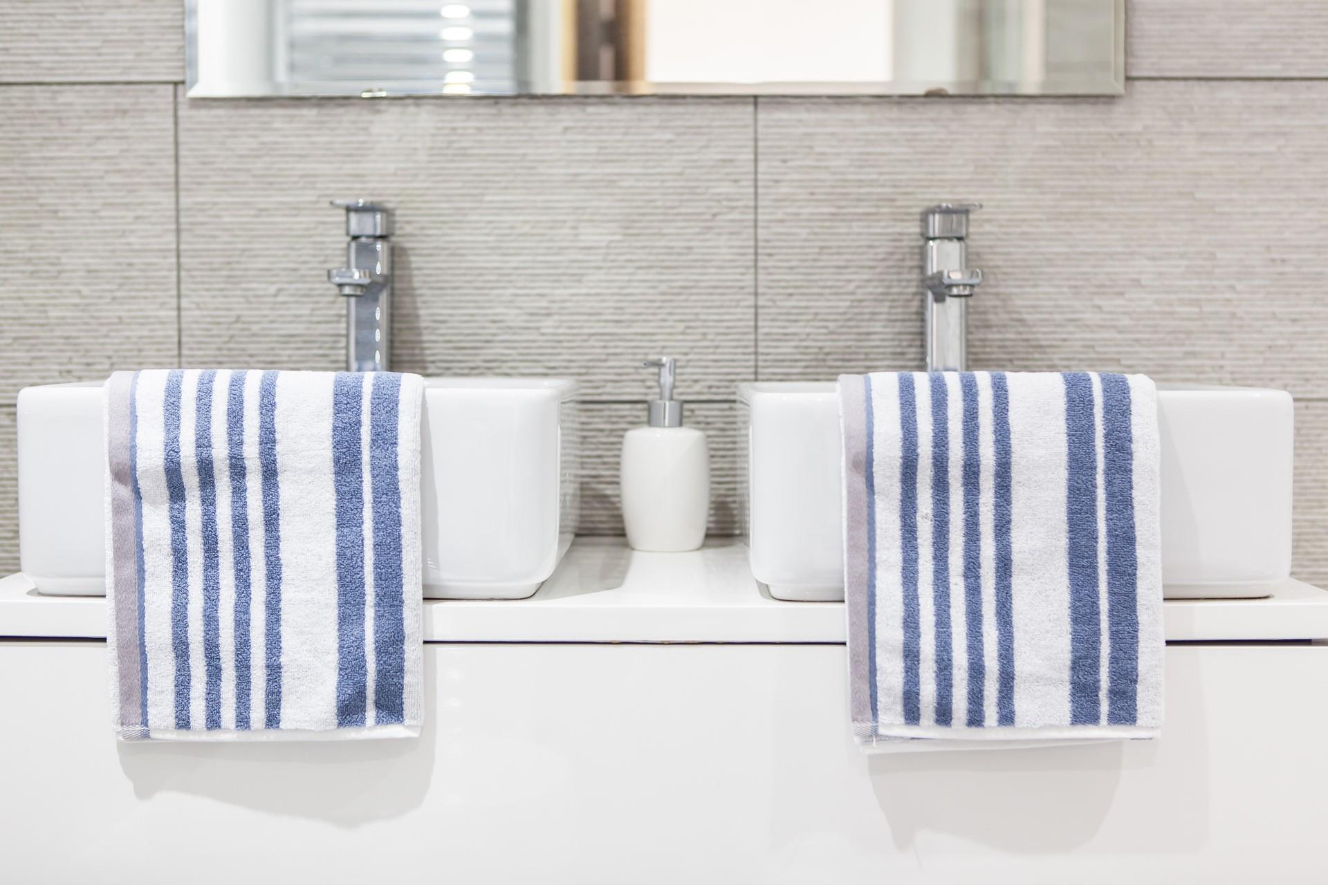 The stunning family bathroom benefits from Jack and Jill basins.