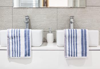 The stunning family bathroom benefits from Jack and Jill basins.