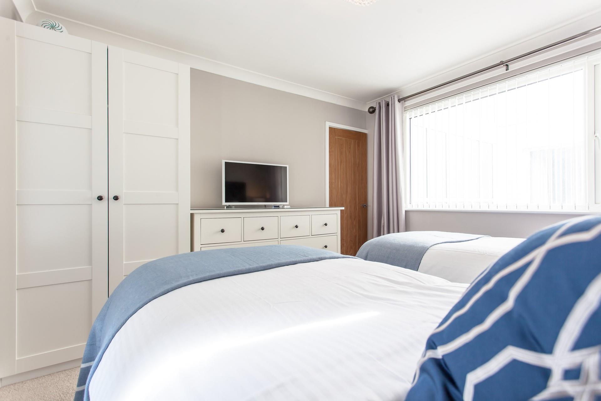 The second bedroom benefits from ample storage space and a large window, allowing plenty of natural light in. 