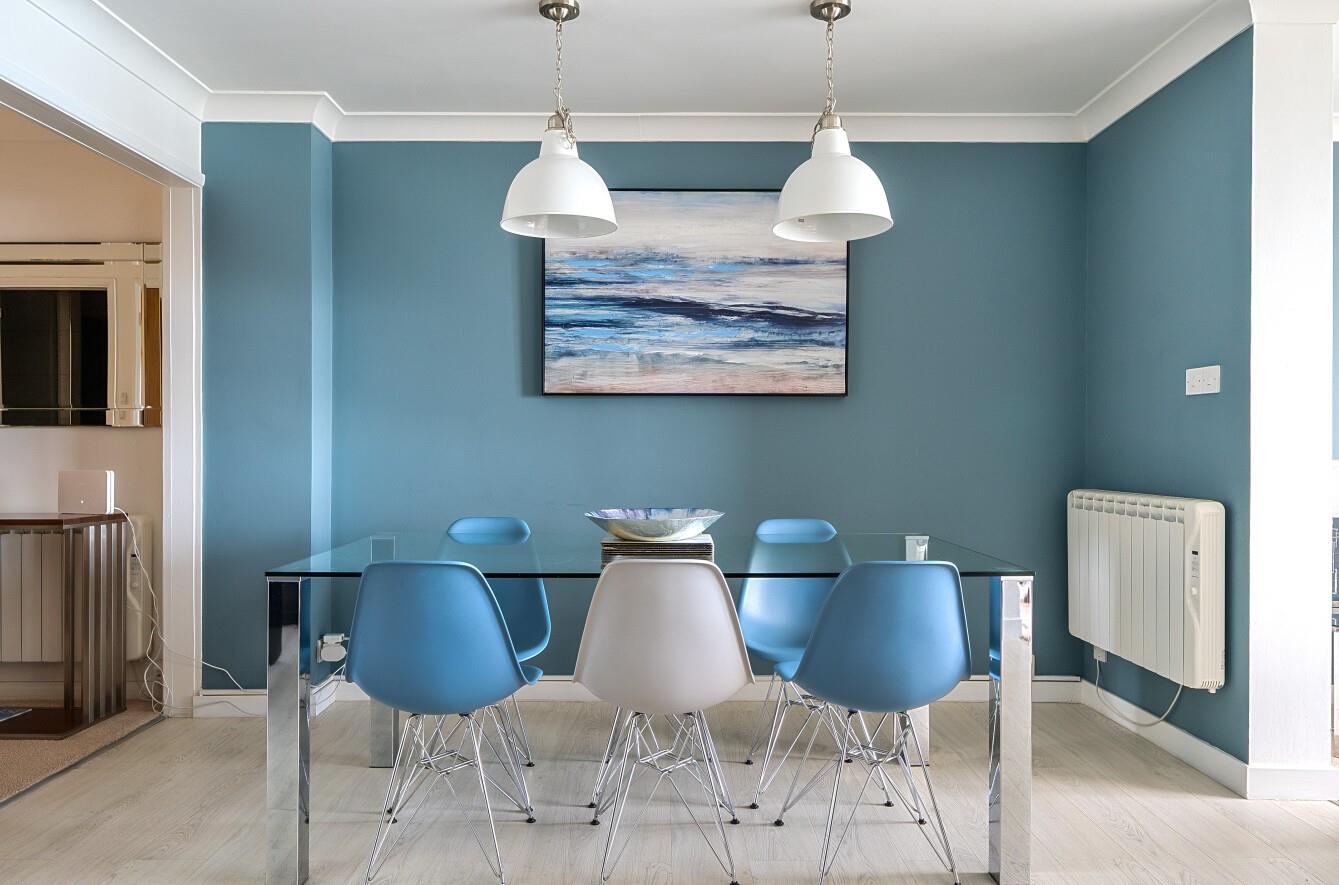 Coastal-inspired artwork features in the modern open plan living area.