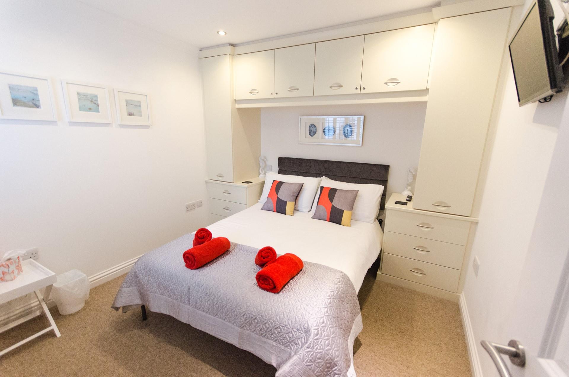 The master bedroom is wonderfully spacious with lots of storage for all your holiday best.