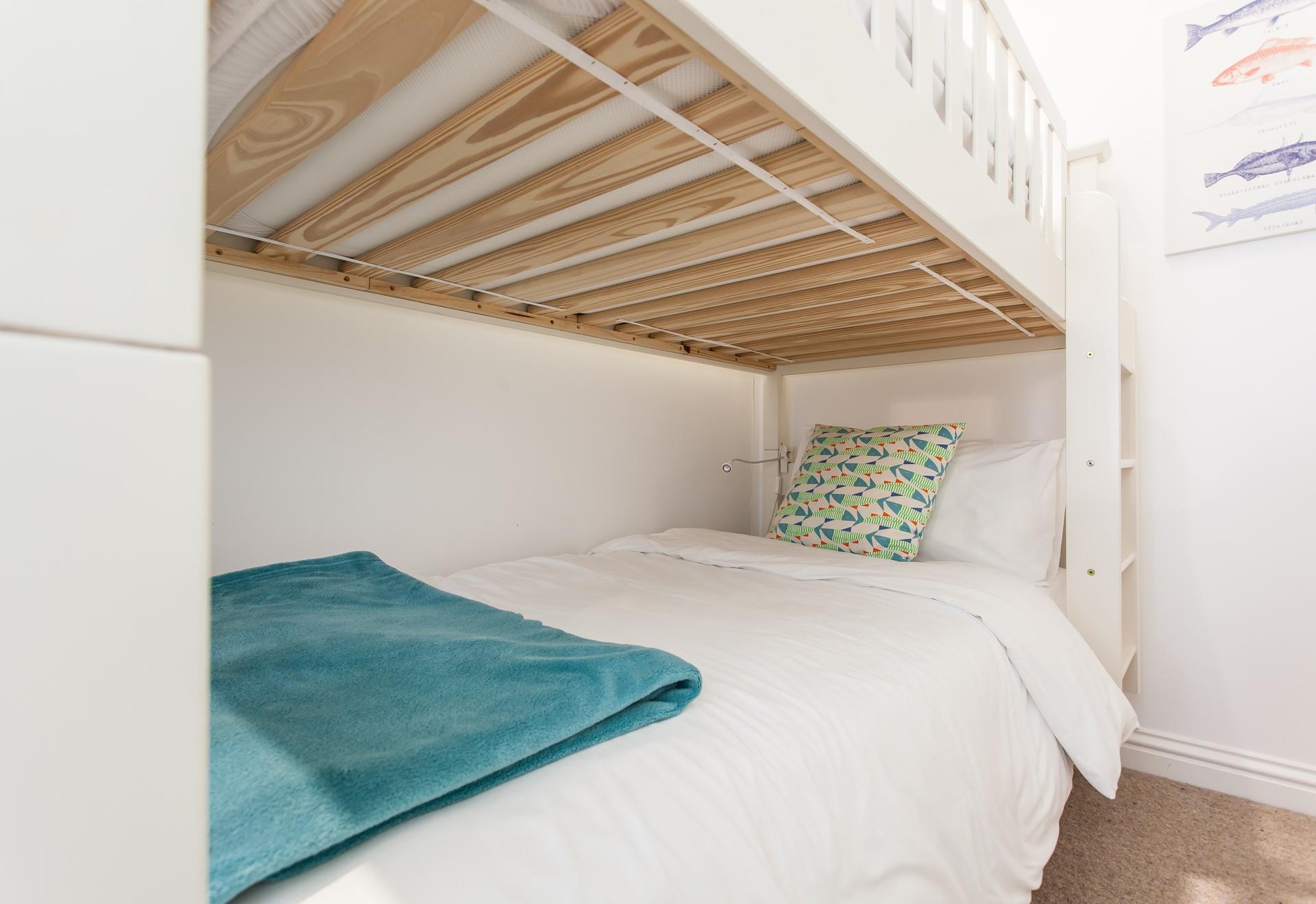 Crisp white linen mixes with bold prints to create a calming yet fun space.