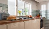 The modern kitchen is well-equipped for the chef of the family to whip up a culinary delight. - Thumbnail Image