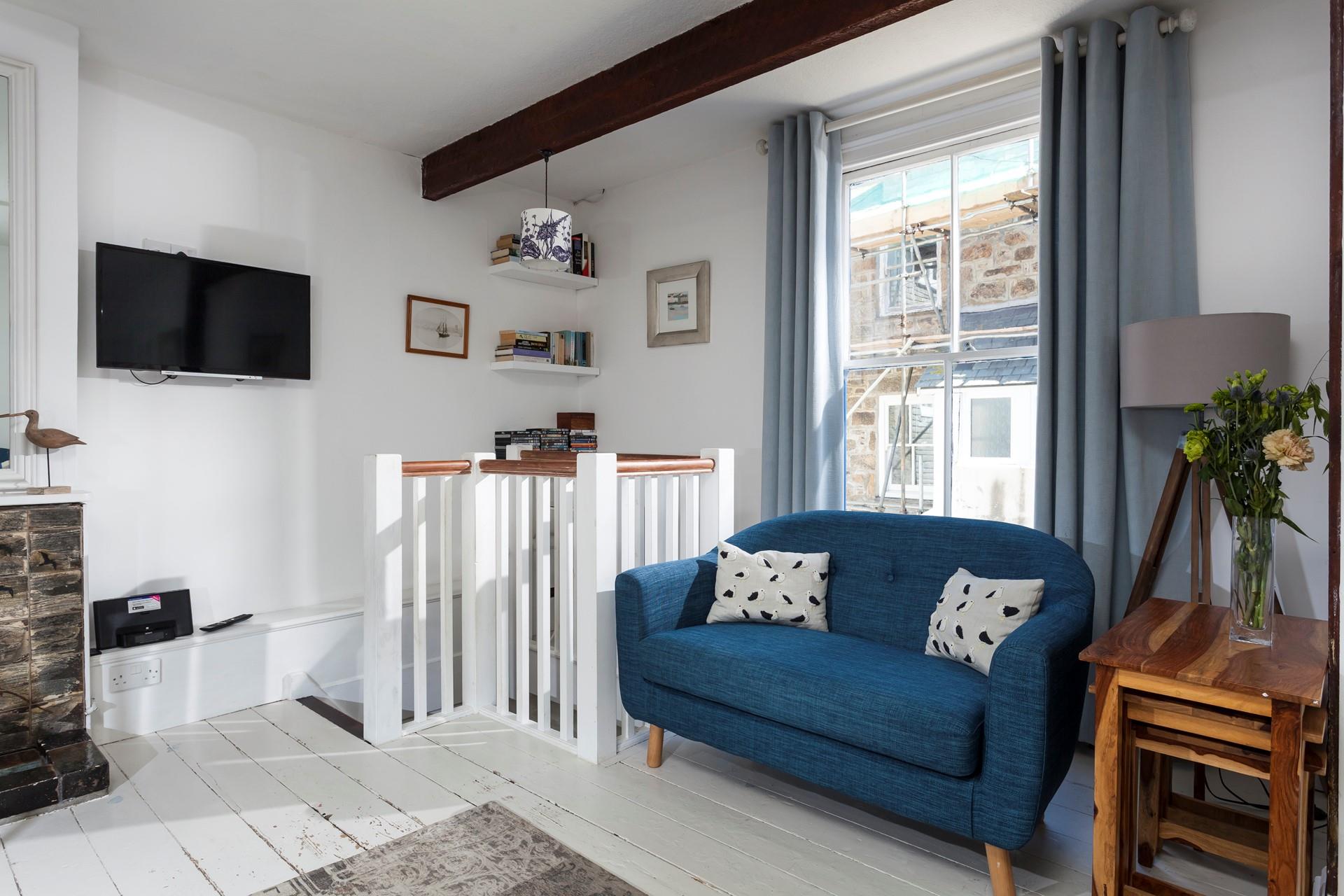 Put your feet up in the cosy sitting room after a busy day on the beach.