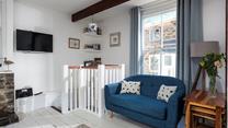 Put your feet up in the cosy sitting room after a busy day on the beach.