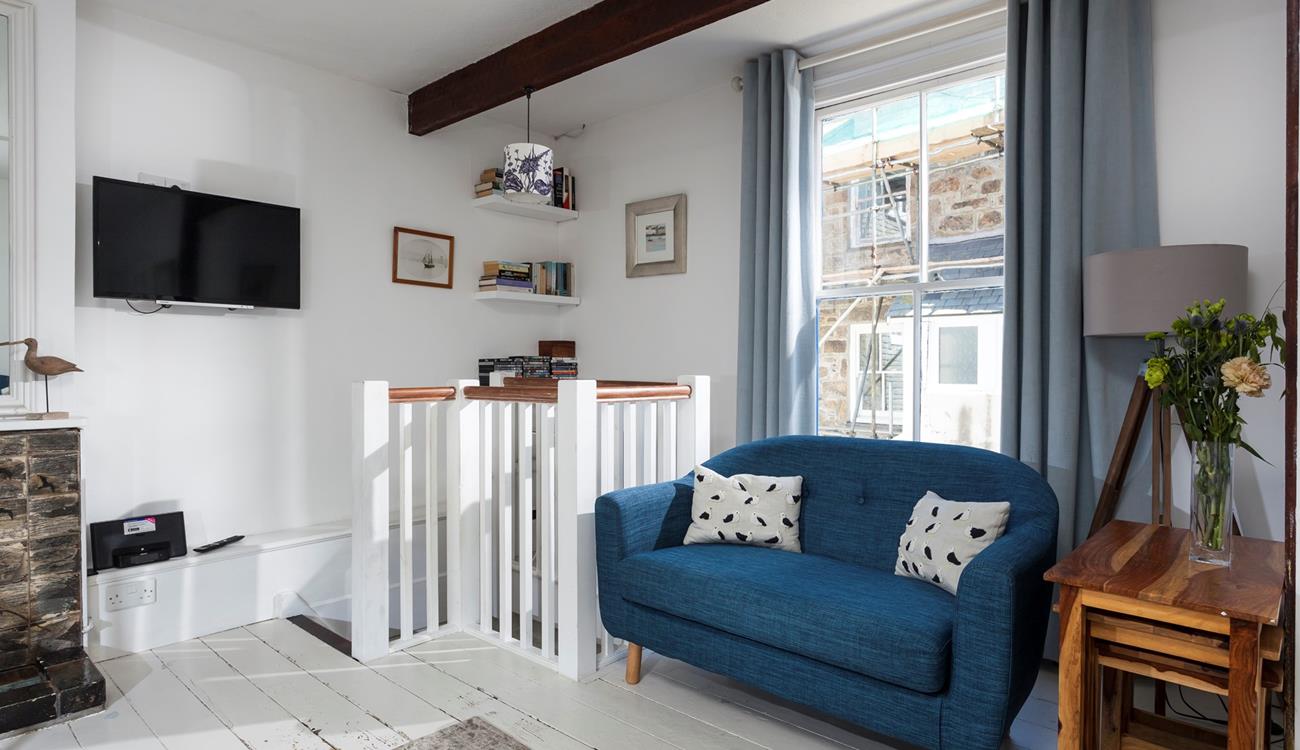 Put your feet up in the cosy sitting room after a busy day on the beach.