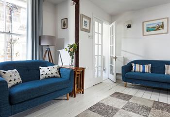 The blue and white interiors create a calming atmosphere in your cosy sitting room.