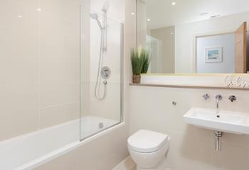 Sink into the bath in the family bathroom, enjoying a moment of calm.