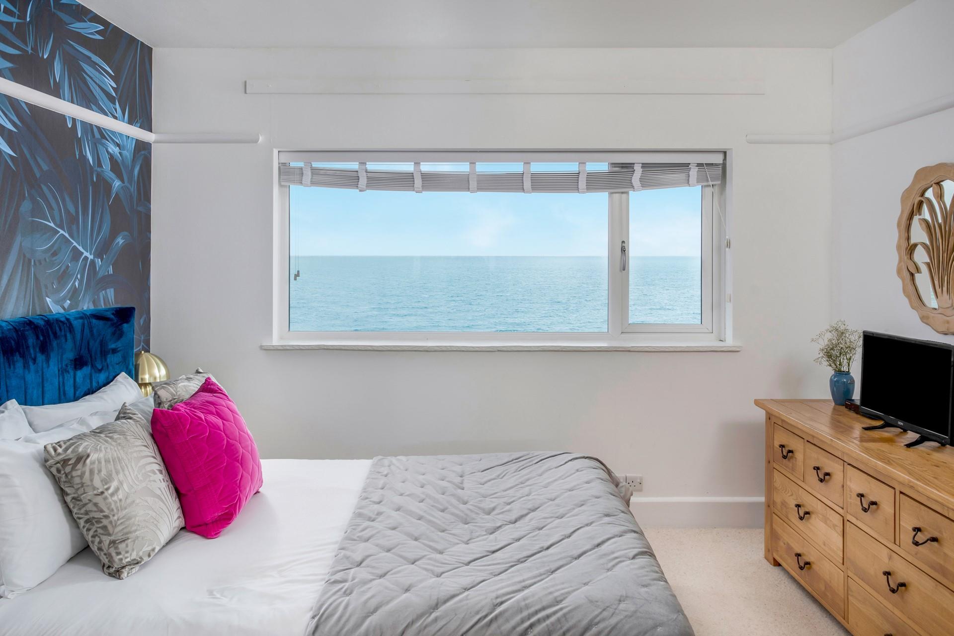 The bedroom is stylishly decorated with sea views to wake up to.