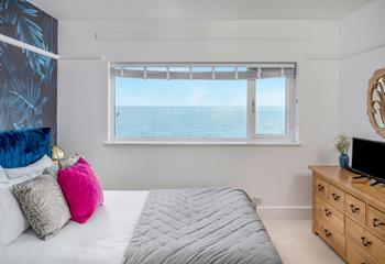 The bedroom is stylishly decorated with sea views to wake up to.