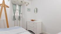 Calming coastal decor creates a relaxing bedroom.