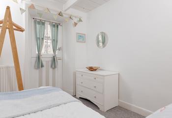 Calming coastal decor creates a relaxing bedroom.