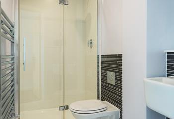 The en suite has a fresh, modern feel and provides space and privacy to get ready.