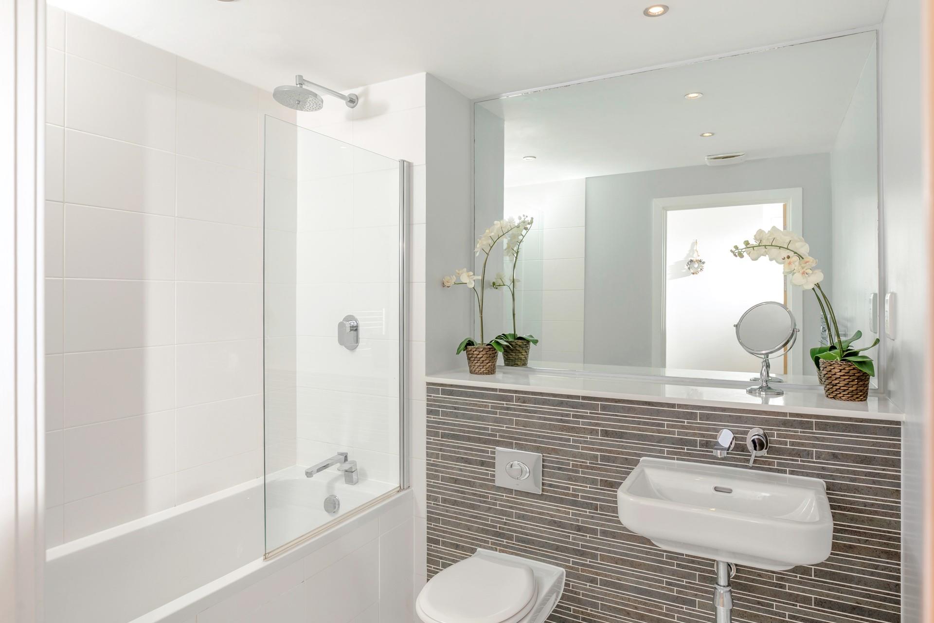 The en suite has a fresh, modern feel and provides space and privacy to get ready.