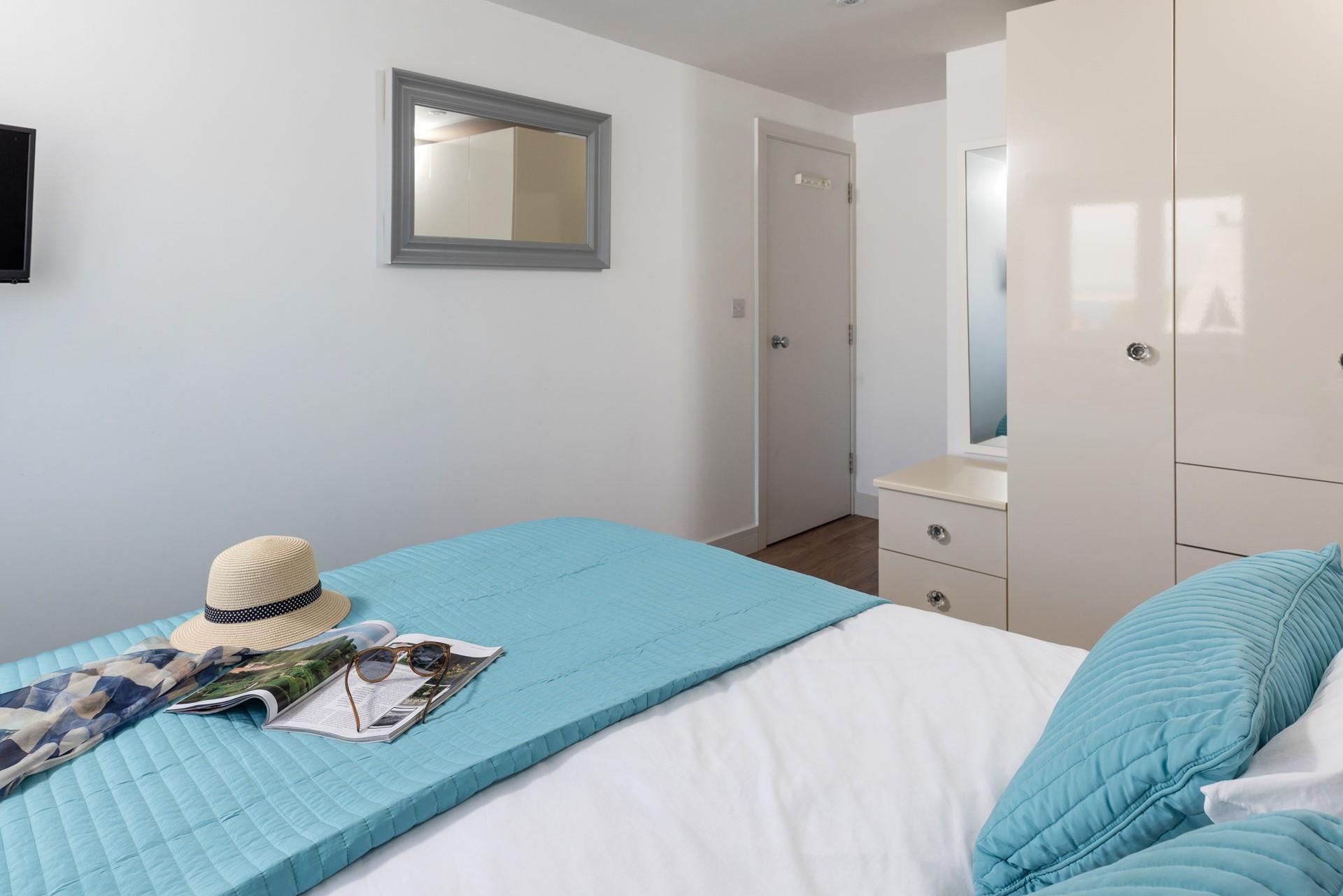 Decorated in coastal blues, relax and unwind in the bedroom.