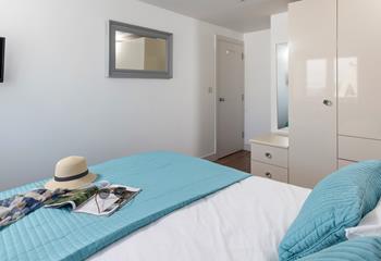 Decorated in coastal blues, relax and unwind in the bedroom.