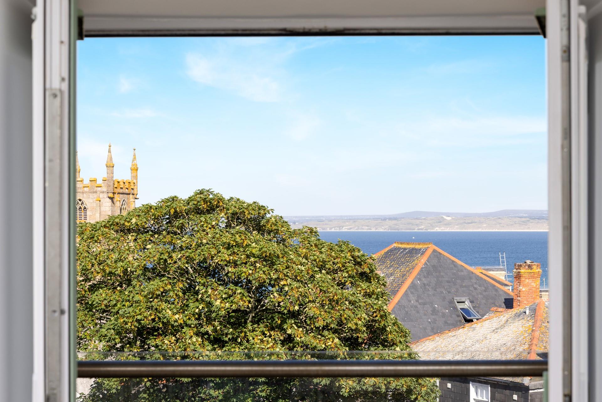 The view from the balcony sweeps across St Ives Bay.