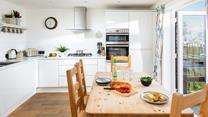 Sleek yet cosy the kitchen and dining space. 