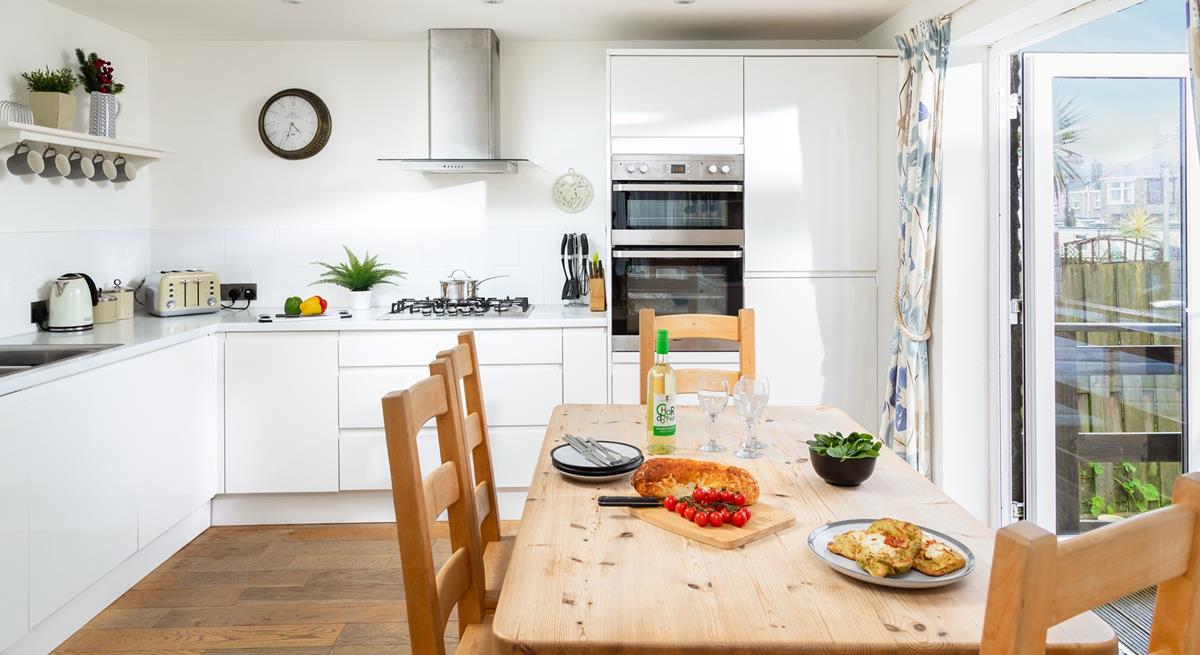 Sleek yet cosy the kitchen and dining space. 