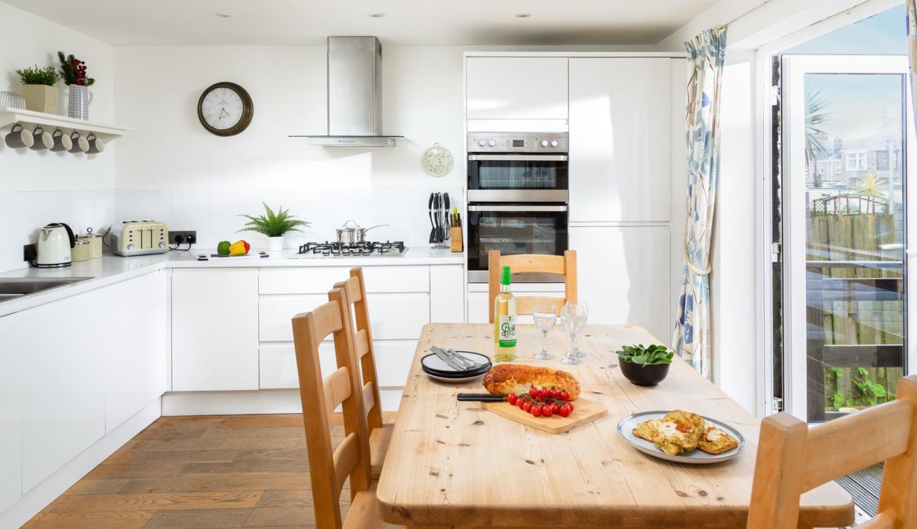 Sleek yet cosy the kitchen and dining space. 