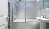 Get ready for the day in the stylish and modern bathroom. - Thumbnail Image