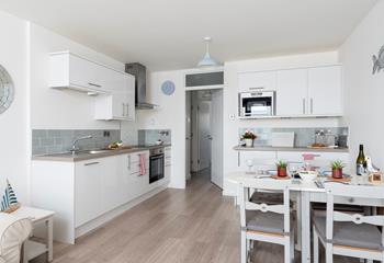 Though compact the kitchen is well-equipped with modern appliances, making it easy to cook delicious meals.