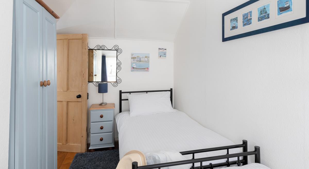 Twin beds and fun decor make this bedroom perfect for kids and young adults.