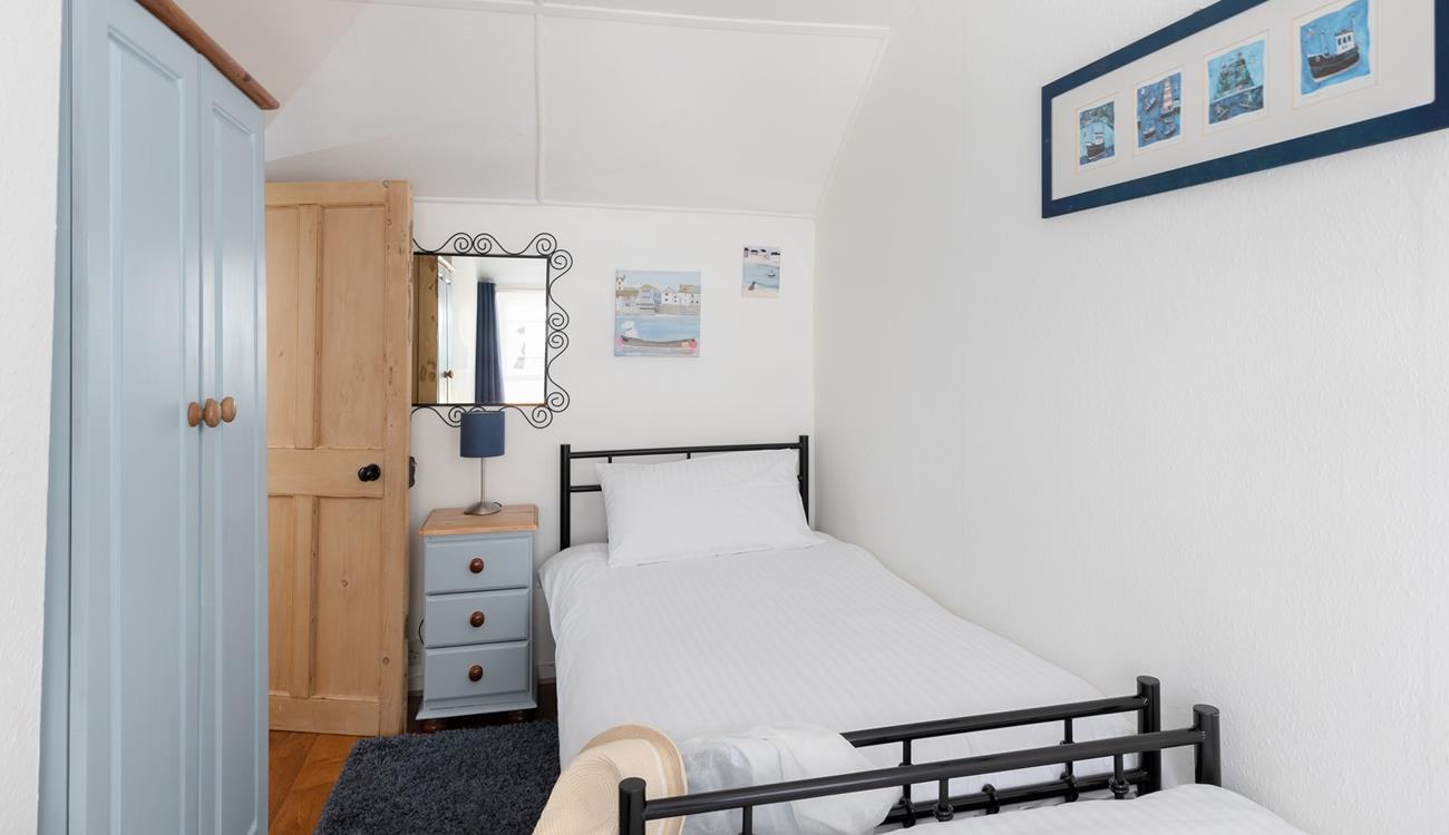 Twin beds and fun decor make this bedroom perfect for kids and young adults.