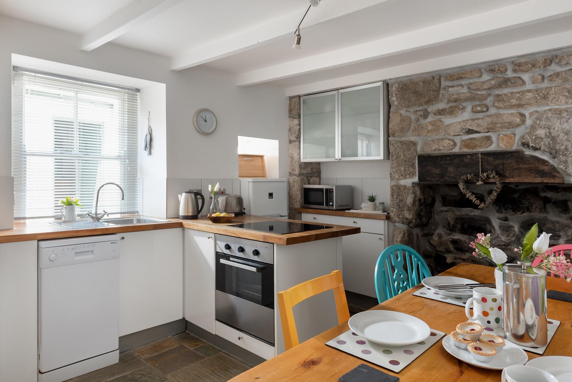 The kitchen blends rustic charm with modern appliances to make cooking an absolute pleasure.