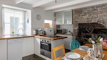 The kitchen blends rustic charm with modern appliances to make cooking an absolute pleasure.