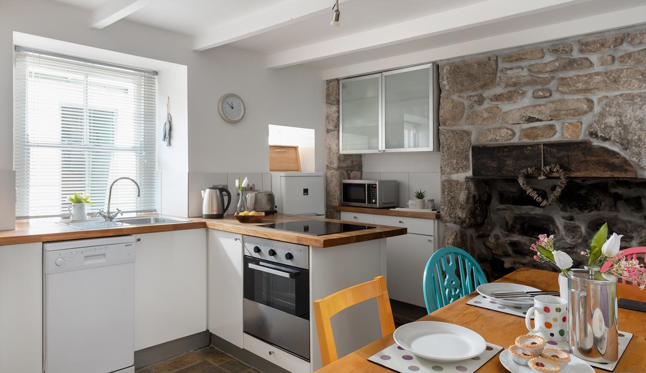 The kitchen blends rustic charm with modern appliances to make cooking an absolute pleasure.