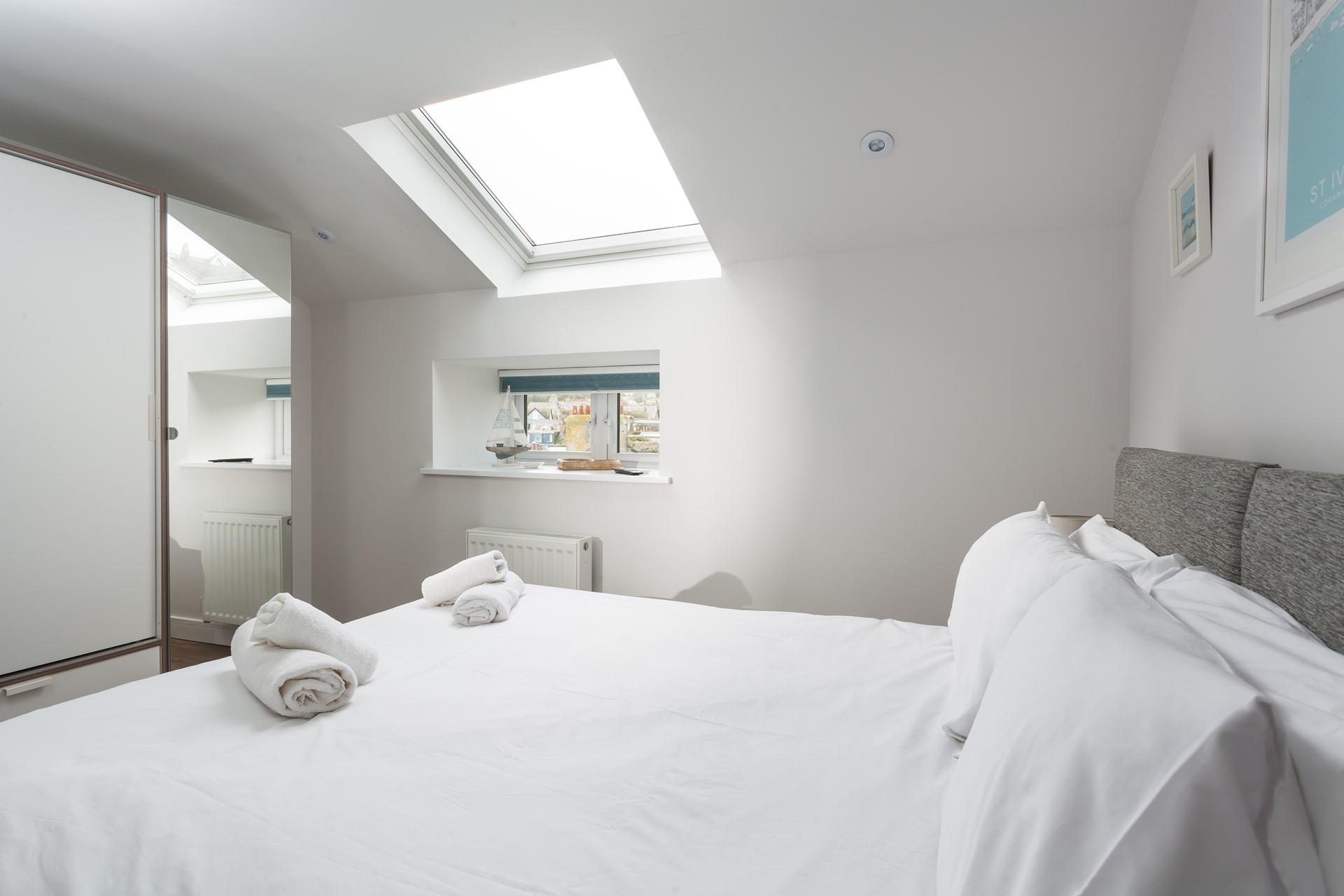 The charming nautical-themed bedroom reminds you just how close to the seaside you are.