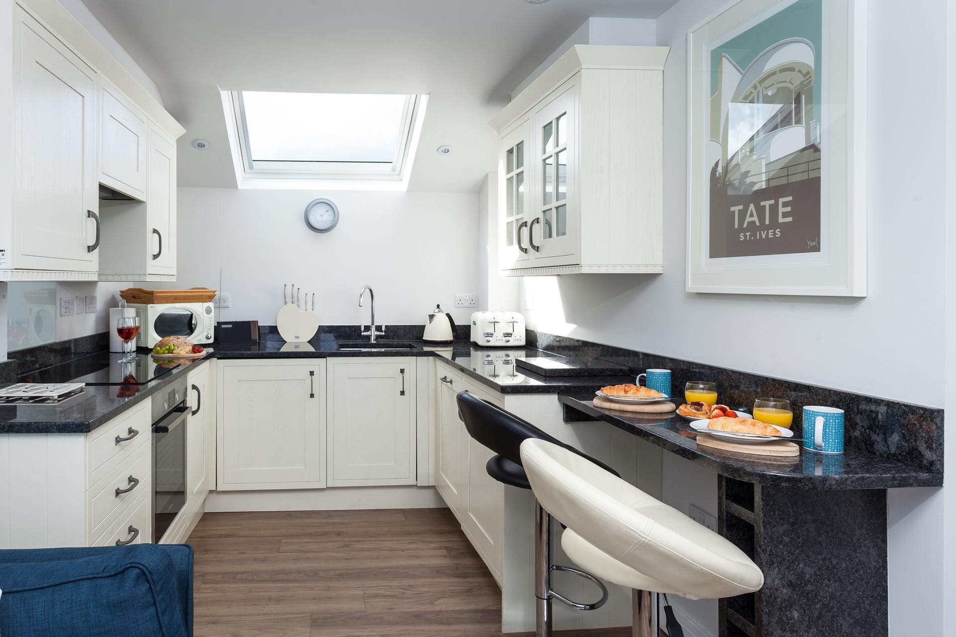 The kitchen is fabulously well-equipped whilst the skylight window lets the summer light shine down on you as you cook.