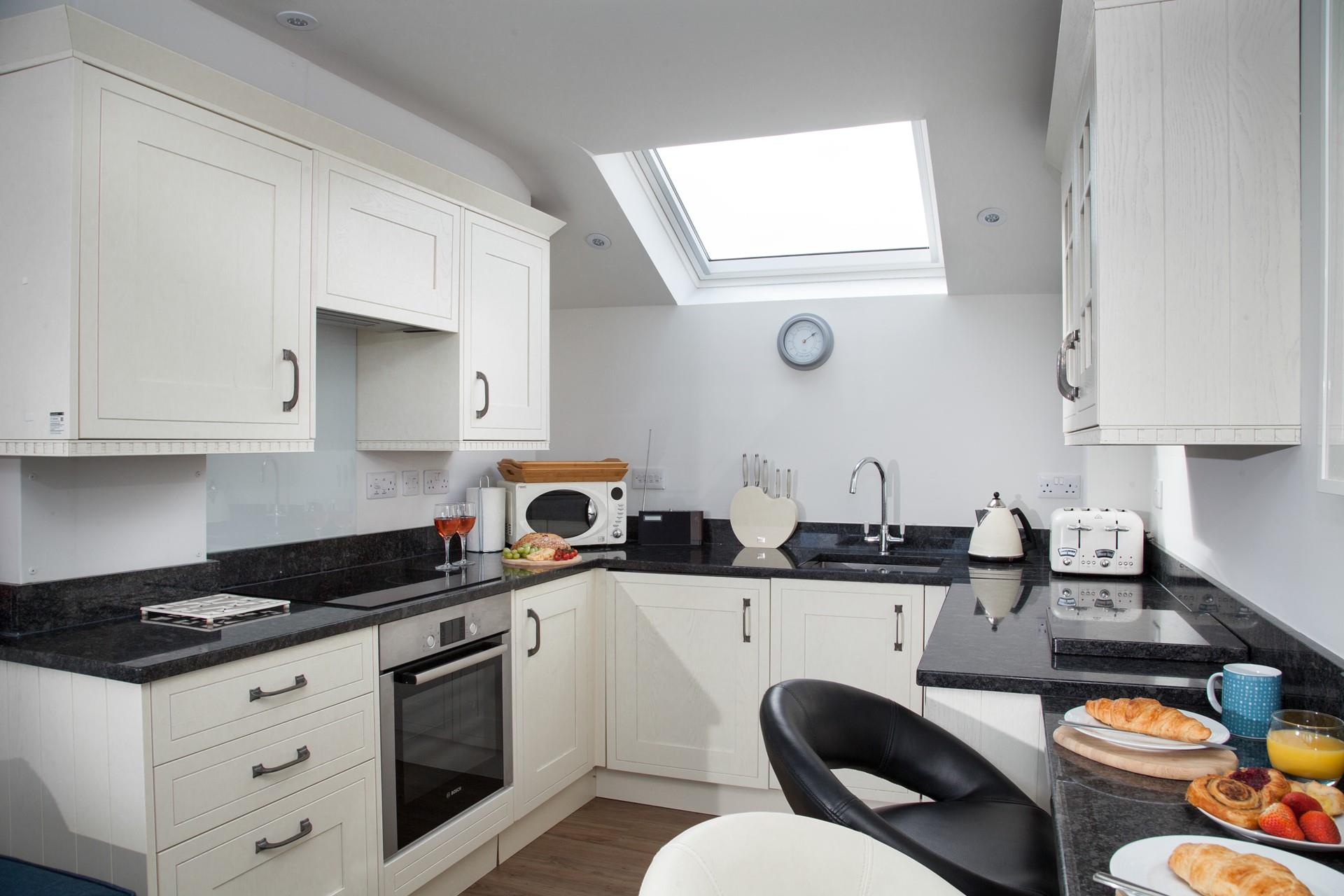 Decorated in a neutral palette, the kitchen is a stylish space to whip up delicious meals with ease.