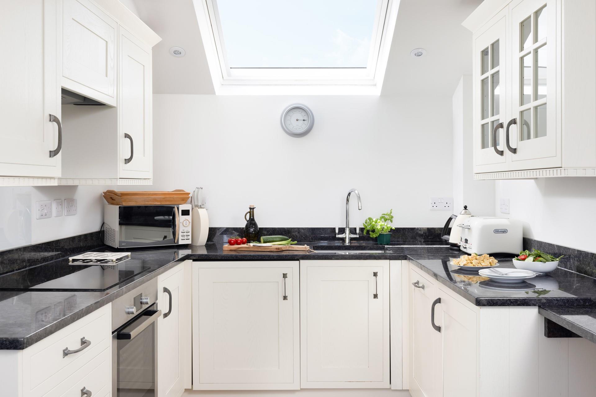 Decorated in a neutral palette, the kitchen is a stylish space to whip up delicious meals with ease.