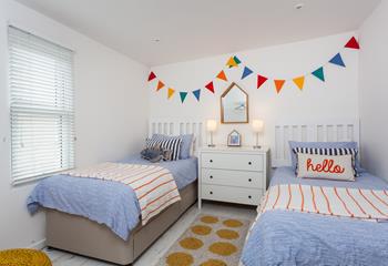 Bedroom 3 has twin beds and is colourfully decorated.