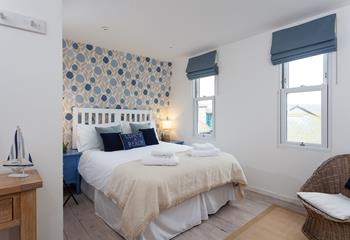 Bedroom 4 has a double bed and is decorated with calming blue tones.