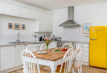 The kitchen is filled with all the appliances you'll need including a bright yellow SMEG fridge!