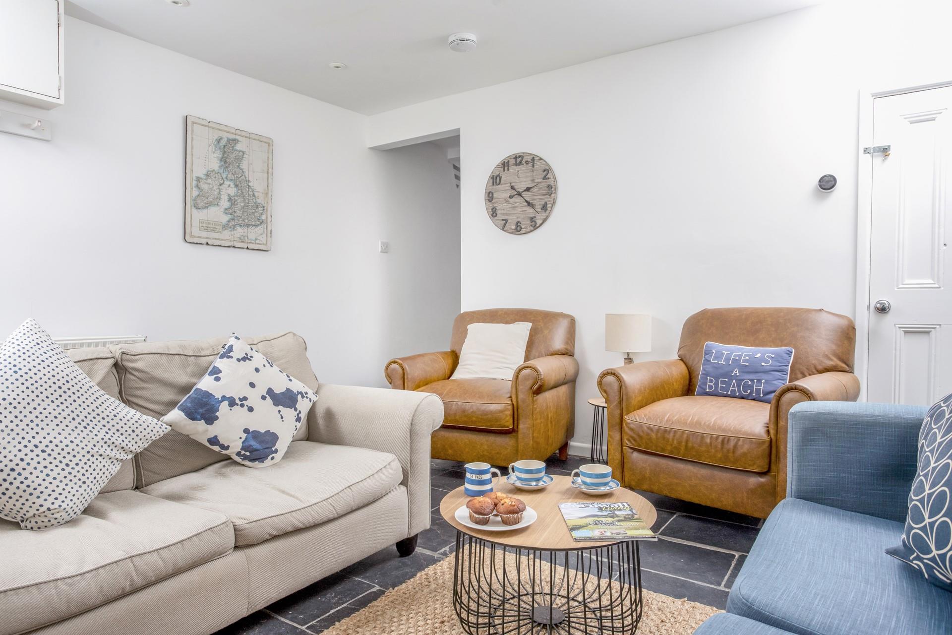 The sitting room is decorated with a nautical theme to reflect the close proximity to the sea.