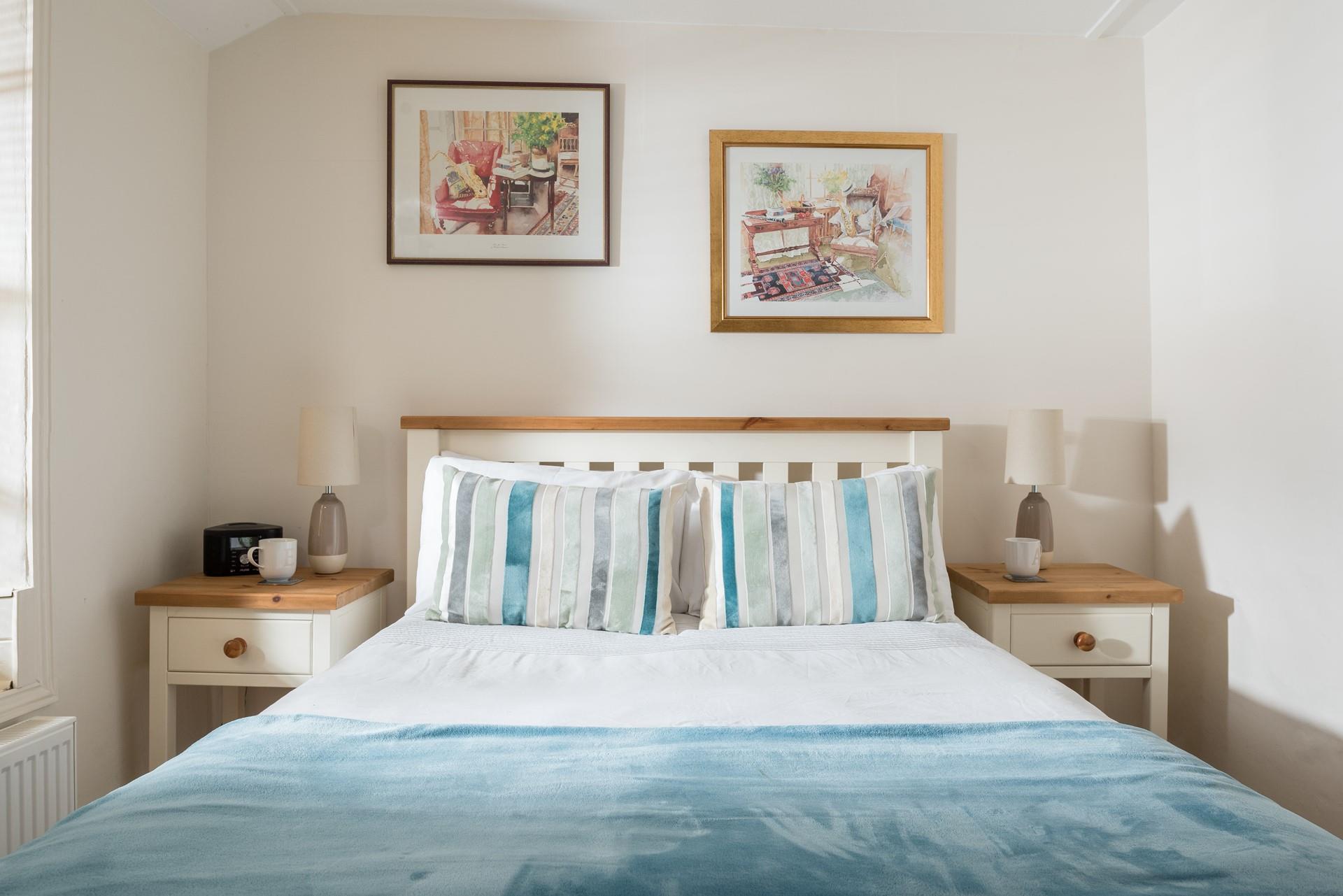 Bedroom 2 has cosy blue interiors and offers a dreamy night's sleep.