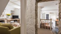 The cottage retains its original features like the granite walls.