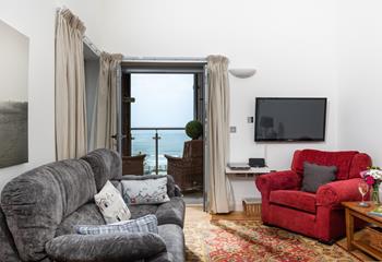 The comfortable sitting area is great for relaxing. Why not open the balcony doors and let in the fresh sea air?