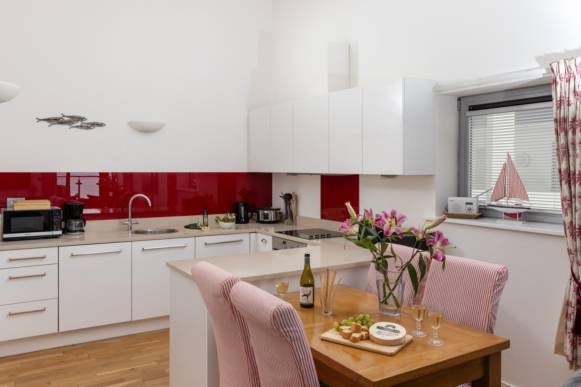 The kitchen is well-equipped with delightful seaside-themed touches!