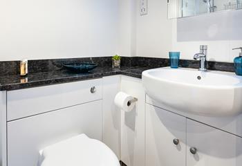 The bathroom blends together practicality and style, creating a bright and fresh space.